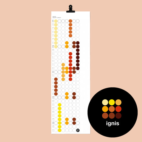 dot on weißer Monatsplaner Wandkalender mit Klebepunkten im Format 23x72 cm beklebt mit Klebepunkten in warmen Farben wie gelb, orange, rot, dunkelrot und schwarzer Metallklammer