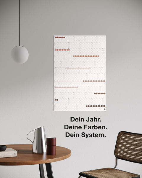 dot on Jahresplaner Wandkalender mit Klebepunkten im Hochformat 67x100 cm beklebt mit Klebepunkten in Erdtönen an Zimmerwand beidseitig bedruckt schwarze und weiße Seite